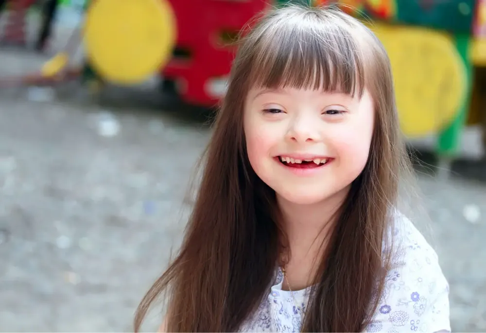 A smiling child supported by Divine Care SA