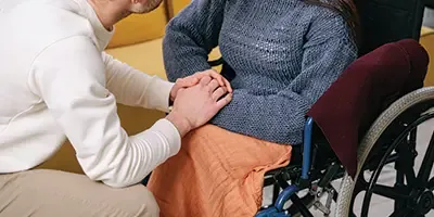 A support worker assisting a person using a wheelchair at home