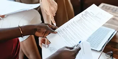 Two people reviewing an NDIS plan document together